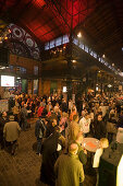 People standing in market hall, fish market in the morning, St. Pauli, Hamburg, Germany