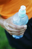 Hand with water bottle