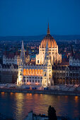 View over the Danube river to the illuminated Parliament at night, Pest, Budapest, Hungary