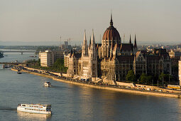 View over the Danube river with boats to the Parliament, Pest, Budapest, Hungary