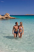 Couple at Spiaggia Capriccioli, Costa Smeralda, Sardinia, Italy