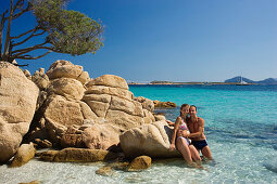 Couple at Spiaggia Capriccioli, Costa Smeralda, Sardinia, Italy