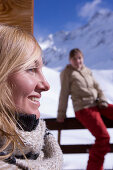Two young women sunbathing on terrace of ski lodge, Kuehtai, Tyrol, Austria
