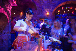 Young woman preparing drinks in the nightclub Hamam Club, Kos-Town, Kos, Greece