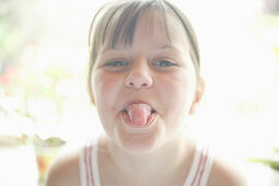 Girl sticking out tongue, portrait