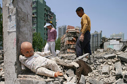 demolition, doll, redevelopment area, migrant construction worker clearing bricks, Living amongst ruins, encroaching new highrise