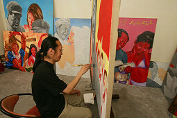 Lao Fan,Painter Lao Fan in his studio, paints chairman Mao in combination with, attractive and sexy girls, power, Vorsitzender Mao als Playboy, womanizer, red guards, Mao-Bibel, little red book