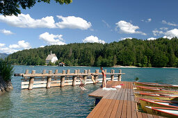 Children diving from jetty, Walchensee, Bavaria, Germany