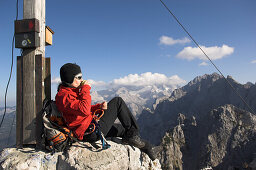 Female mountain climber on the summit of the Dachstein Mountains, Austria