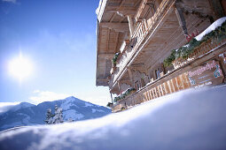 Typical Tyrolean holiday home and restaurant in the snow, Nieding, Brixen im Thale, Tyrol, Austria