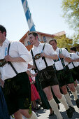 Young men in traditional bavarian clothes at 1st of May celebration, Muensing, bavaria, Germany