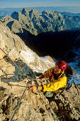 Woman climbs a Via Ferrata to the top of  Triglav. Triglav, Triglav Nationalpark, Julian Alps, Slovenia, Alps.