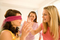 Teenage girls (14-16) playing Blind Man's Bluff