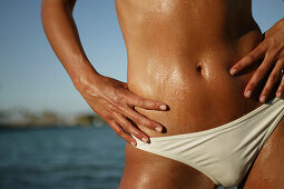 Young woman standing with hands on hips, close up