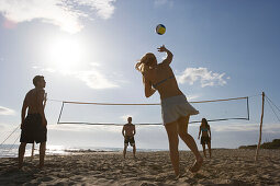 Young people playing beach volleyball, Apulia, Italy