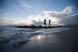 Couple walking on beach, evening mood, Apulia, Italy