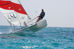 Man sailing on catamaran, Apulia, Italy