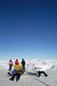 Tourists at snow covered landscape, Passo Pordoi, Dolomites, Italy, Europe