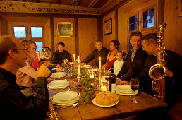 People having christmas dinner in traditional dinning room, St. Moritz, Switzerland