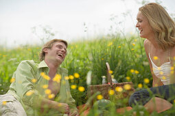 Couple having picnic on meadow