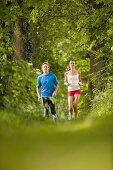 Couple jogging in woods