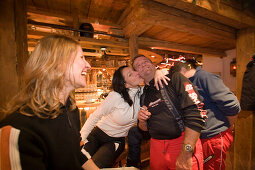Two girls and a man dancing and enjoying an Apres-ski party at Purzelbaum Alm, Flachau, Salzburger Land, Austria