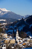 View over evangelical church Peter and Paul to the summit of the Dachsteinregion at horizon, Schladming, Ski Amade, Styria, Austria
