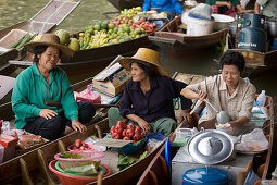 Laughing market-woman holding a dish, another watching her, Floating Market, Damnoen Saduak, near Bangkok, Ratchaburi, Thailand