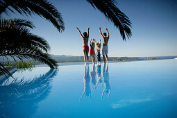 Family on poolside, Bay of Porto Vecchio, Southern  Corse, France