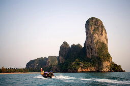 Longtail boat to Railay West with chalk cliff, Laem Phra Nang, Railay, Krabi, Thailand