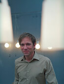 Man standing in the kitchen, lights around his head