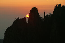 red sunrise with mountain silhouette, Northern Sea, Huang Shan, World Heritage, UNESCO, Anhui province, China, Asia