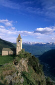 church of San Romerio above the valley of Puschlav with range of Bergamask alps in background, Puschlav, Grisons, Switzerland