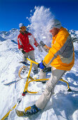 A couple having fun while snowbiking downhill,  Serfaus, Tyrol, Austria