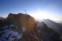 Mann am Zugspitzgipfel im Morgenlicht, Bayern, Deutschland