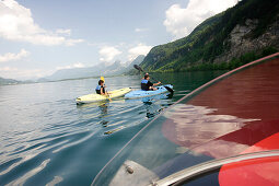 A motor boat and two canoes near St. Gilgen, Lake Wolfgangsee, Salzburg, Austria
