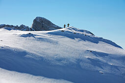 Two men carry their snowboards to the top of a mountain, Appenzell, St. Gallen, Toggenburg, East Switzerland, Switzerland, Alps