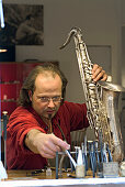 Man reparing saxophone, Munich, Bavaria, Germany