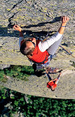 Young woman freeclimbing at rock, Bernese Oberland, Canton Uri, Switzerland, MR