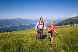 Couple hiking above Millstaetter See, near Millstatt, Carinthia, Austria