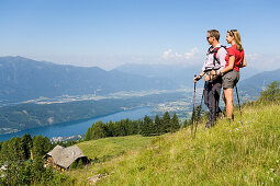 Couple enjoying the view over the Millstaetter See, 1650 m the deepest lake in Carinthia, Lammersdorf near Millstatt, Carinthia, Austria