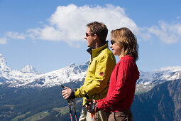 Couple enjoying view over Bernese Alps, Bussalp (1800 m), Grindelwald, Bernese Oberland (highlands), Canton of Bern, Switzerland