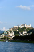 View over the Salzach Hohensalzburg Fortress, the largest fully preserved fortress in central Europe, Salzburg Cathedral and Collegiate Church, Salzburg, Austria. Since 1996 the historic centre of the city is part of the UNESCO World Heritage Site