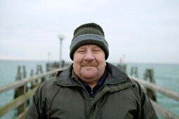 Mature man on pear at Baltic Sea, Mecklenburg-Western Pomerania, Germany