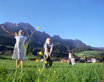 Girl and boy playing on mountain pasture, Leogang, Salzburg (state), Austria