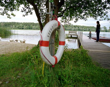 Life saver, mother and child on the jetty of Neuklostersee, Wellness Hotel, Spa Hotel Seehotel Neuklostersee, Mecklenburg - Western Pomerania, Germany