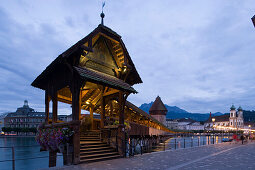 Entry of the Kapellbrücke (chapel bridge, oldest covered bridge of Europe) and Wasserturm in the evening, Jesuit Curch, first large sacral baroque building in Switzerland, in background, Lucerne, Canton Lucerne, Switzerland