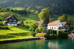 View over Lake Lucerne to Kehrsiten Dorf with church, Canton of Lucerne, Switzerland