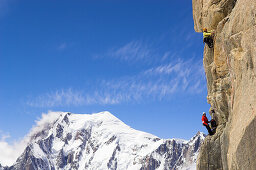 Two climbers at south wall of mount Dent du Geant, Mont Blanc in background, France, Italy