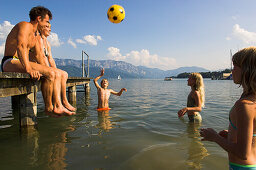 A family bathing in the water at Lake Attersee, Attersee, Upper Austria, Austria